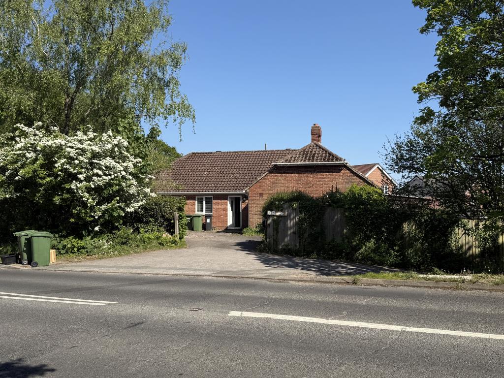 Lot: 112 - VACANT THREE-BEDROOM BUNGALOW ON PLOT OF 0.3 ACRES - Bungalow viewed from road with access gate and driveway